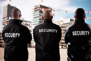 Security Guards Standing Watch of Building Construction Site