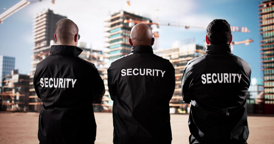 Security Guards Standing Watch of Building Construction Site
