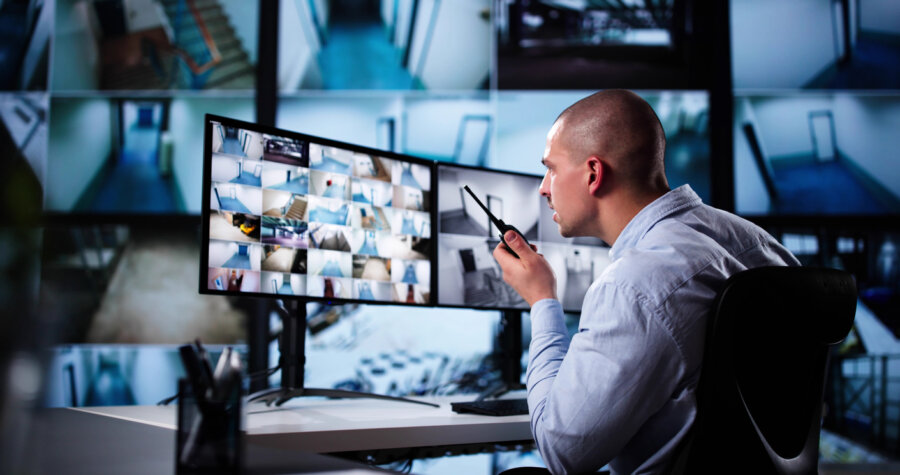 Security System Cctv Monitor Room. Man Using Walkie Talkie stock photo